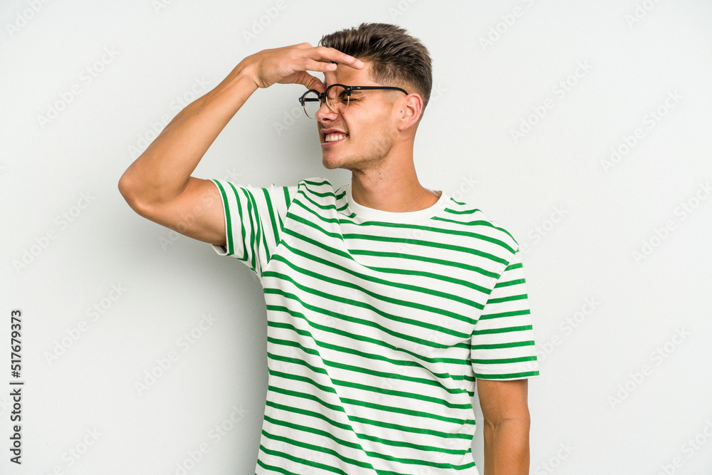 Young caucasian man isolated on white background having a head ache, touching front of the face. Young caucasian man isolated on white background having a head ache, touching front of the face.