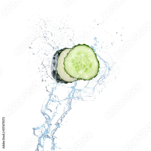 Cucumber slices with water splashing on background.