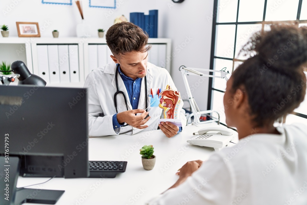 Man and woman wearing doctor uniform having otolaryngology consultation at clinic Man and woman wearing doctor uniform having otolaryngology consultation at clinic