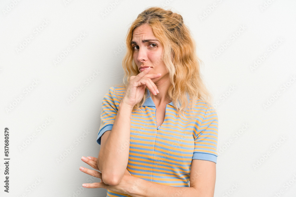 Young caucasian woman isolated on white background thinking and looking up, being reflective, contemplating, having a fantasy. Young caucasian woman isolated on white background thinking and looking up, being reflective, contemplating, having a fantasy.