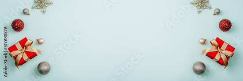 Banner with red gift in a box  Christmas balls and star on light background. Christmas  New Year concept