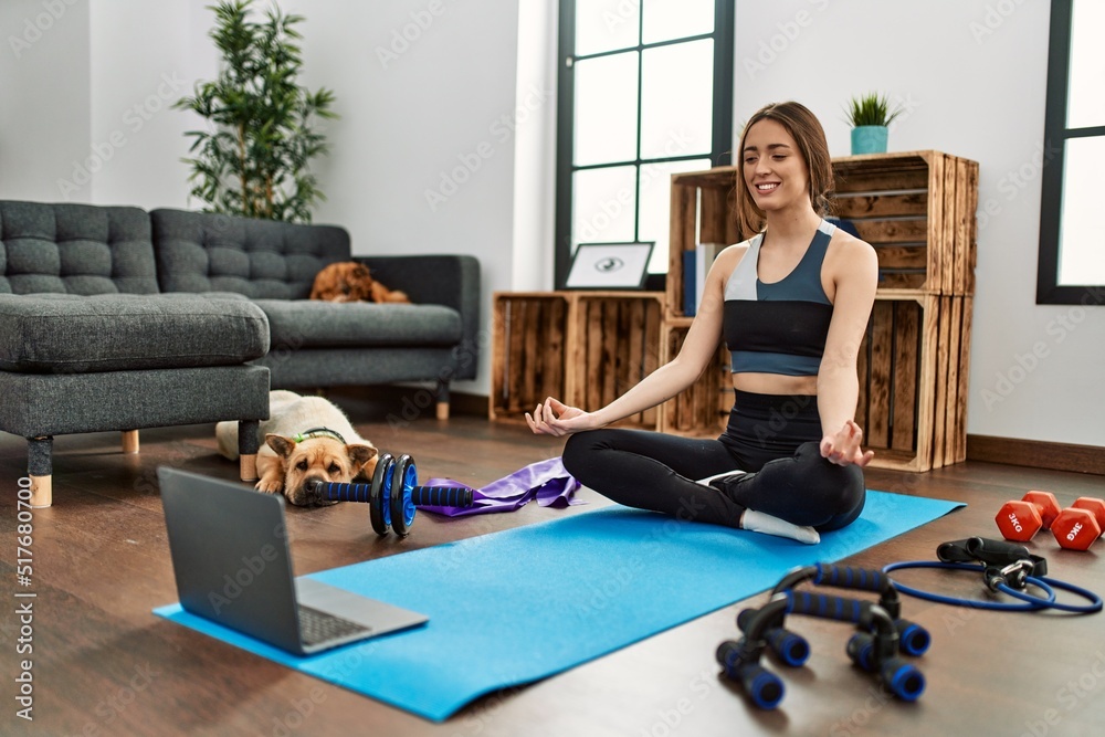 Young hispanic woman smiling confident having online yoga class at home Young hispanic woman smiling confident having online yoga class at home