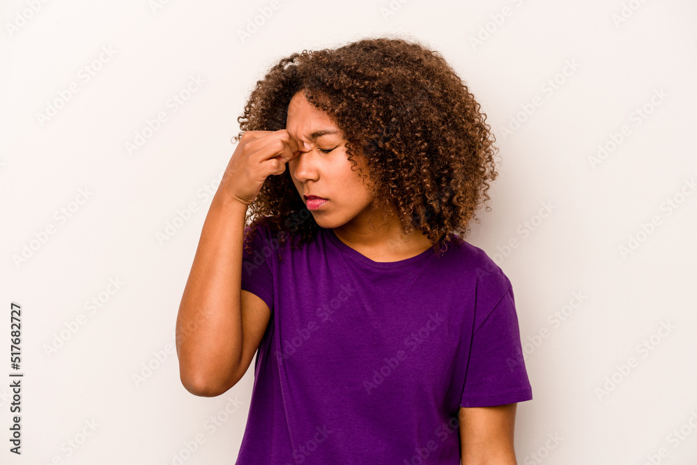 Young African American woman isolated on white background having a head ache, touching front of the face. Young African American woman isolated on white background having a head ache, touching front of the face.