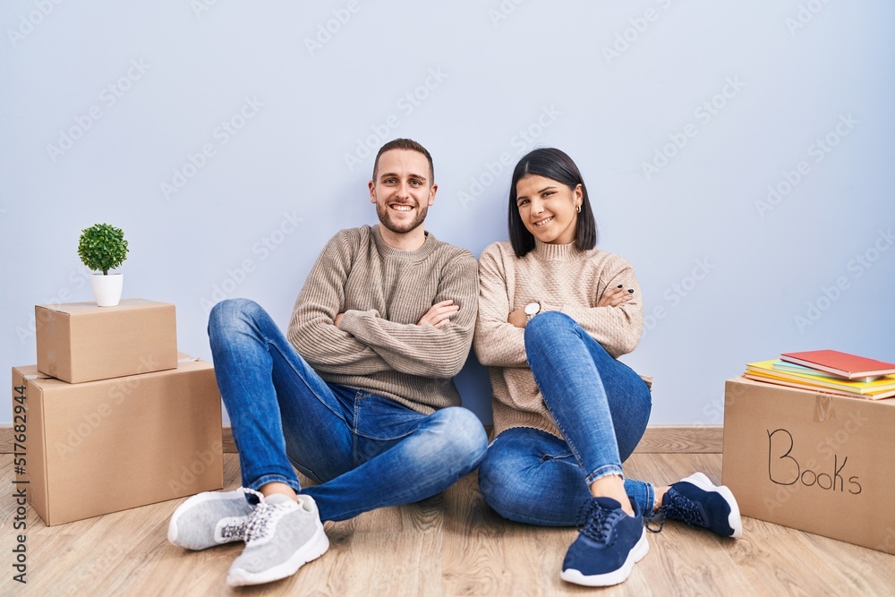 Young couple moving to a new home happy face smiling with crossed arms looking at the camera. positive person. Young couple moving to a new home happy face smiling with crossed arms looking at the camera. positive person.