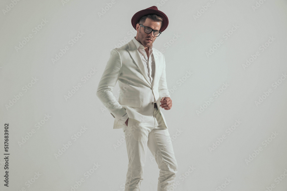 confident elegant man in white suit holding hand in pocket confident elegant man in white suit holding hand in pocket