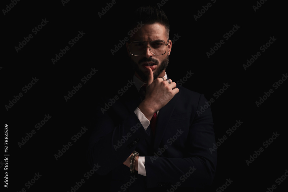 sexy young businessman in suit sensually touching lips and being confident sexy young businessman in suit sensually touching lips and being confident