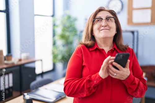 Senior woman business worker using smartphone at office