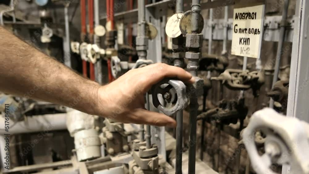 A slow motion video of a man's hand openin and cloding a valve on a plant. Work at the factory. Pipeline opening concept A slow motion video of a man's hand openin and cloding a valve on a plant. Work at the factory. Pipeline opening concept