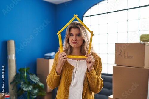 Young woman standing at new home depressed and worry for distress, crying angry and afraid. sad expression. photo