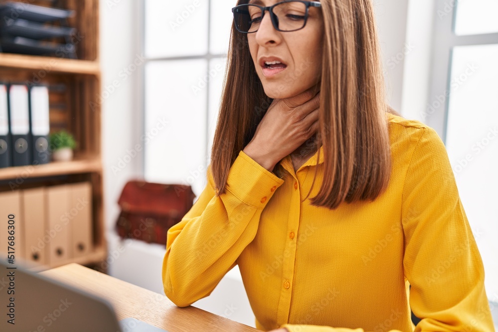 Young woman suffering for throat pain working at office Young woman suffering for throat pain working at office