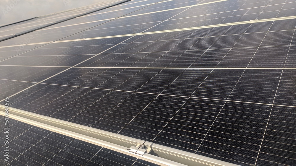 photovoltaic solar panels mounted on building roof for producing clean ecological electricity at sunset. Production of renewable energy concept. photovoltaic solar panels mounted on building roof for producing clean ecological electricity at sunset. Production of renewable energy concept.