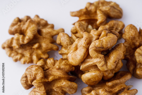 dried walnuts on a white acrylic background