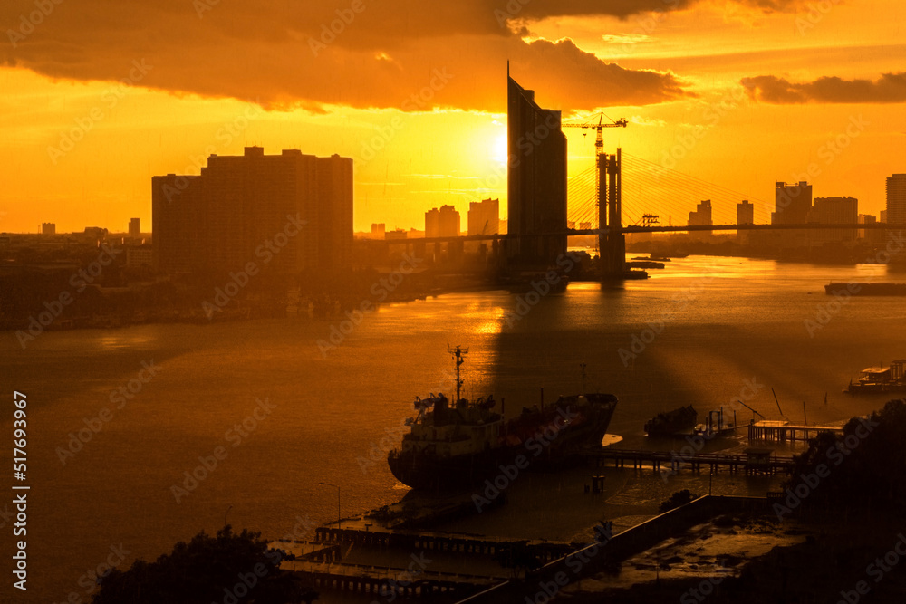 Sunset with raining over Chao Phraya River in Bangkok, Thailand