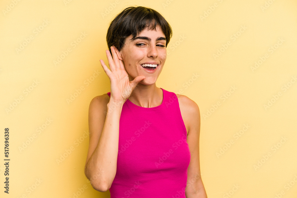 Young caucasian woman with a short hair cut isolated trying to listening a gossip. Young caucasian woman with a short hair cut isolated trying to listening a gossip.