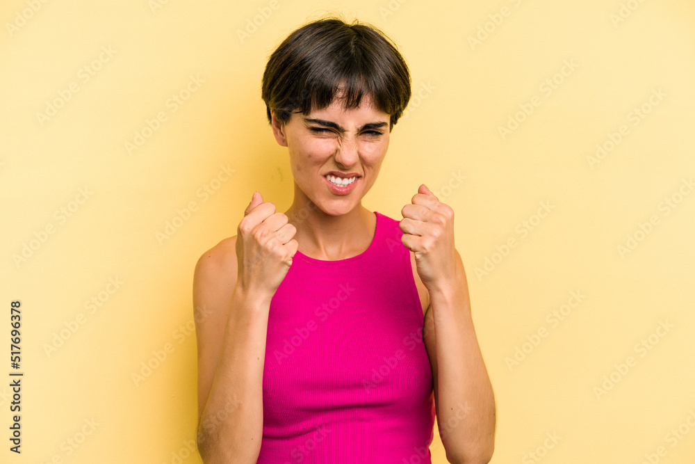 Young caucasian woman with a short hair cut isolated upset screaming with tense hands. Young caucasian woman with a short hair cut isolated upset screaming with tense hands.