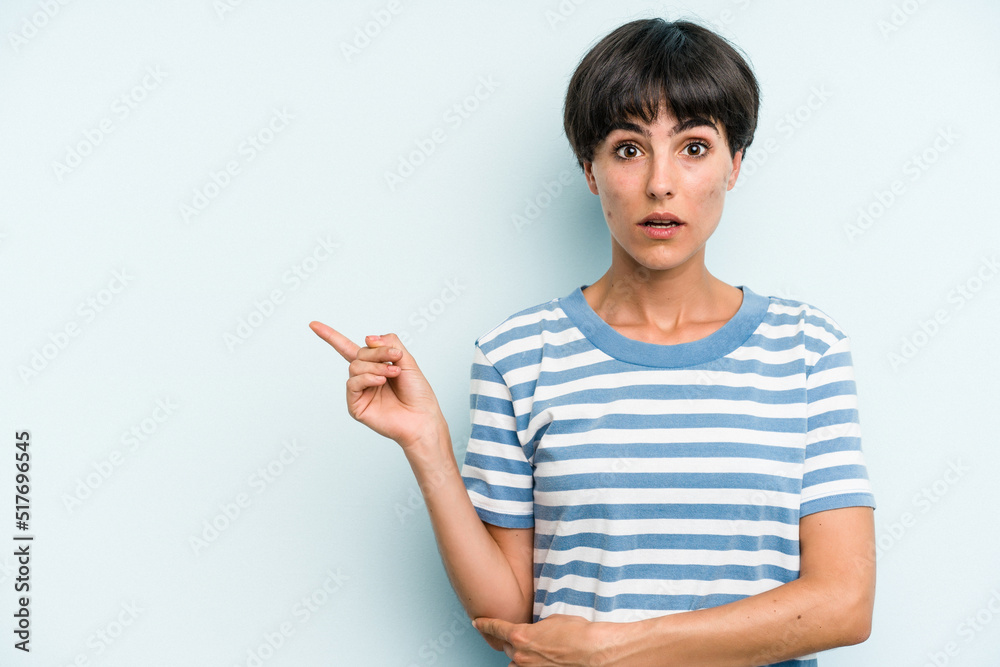 Young caucasian woman with a short hair cut isolated pointing to the side Young caucasian woman with a short hair cut isolated pointing to the side