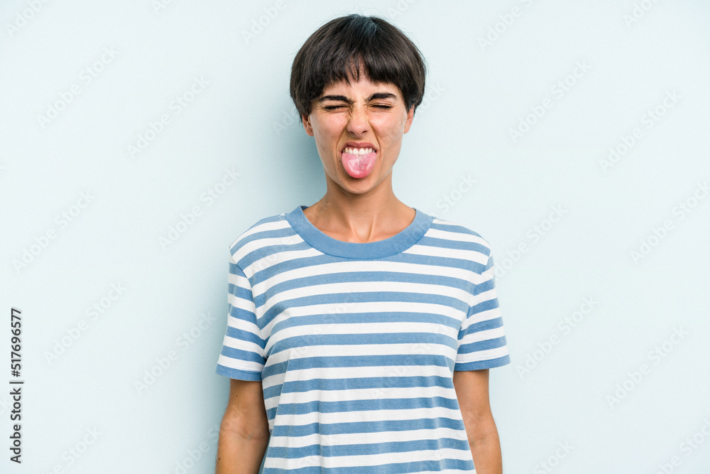 Young caucasian woman with a short hair cut isolated funny and friendly sticking out tongue. Young caucasian woman with a short hair cut isolated funny and friendly sticking out tongue.