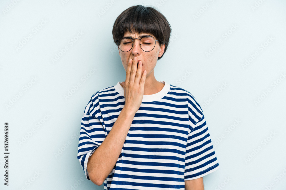 Young caucasian woman with a short hair cut isolated yawning showing a tired gesture covering mouth with hand. Young caucasian woman with a short hair cut isolated yawning showing a tired gesture covering mouth with hand.