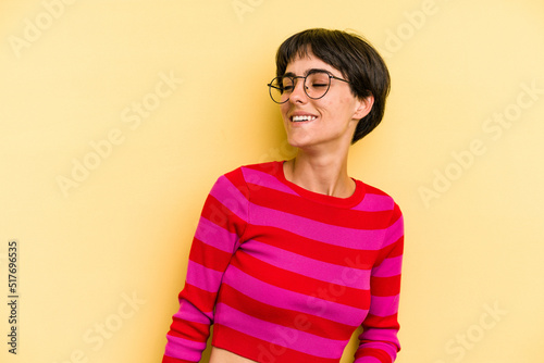 Young caucasian woman with a short hair cut isolated relaxed and happy laughing, neck stretched showing teeth.