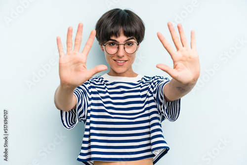 Young caucasian woman with a short hair cut isolated showing number ten with hands.