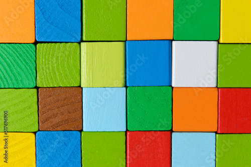 Square shape colorful background in red, yellow, green, and blue created of wooden toy blocks