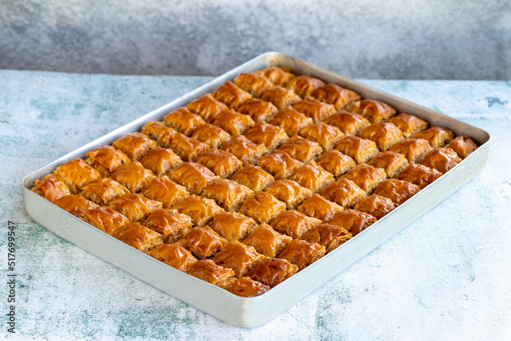 Walnut baklava. Tray baklava on stone background. Turkish cuisine. close up Walnut baklava. Tray baklava on stone background. Turkish cuisine. close up