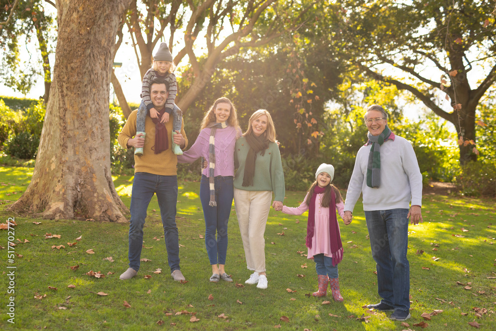 Image of happy multi generation caucasian family in autumn garden