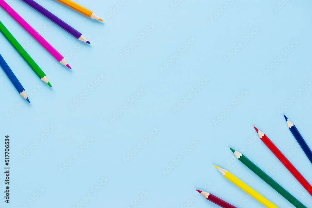 Multi-colored pencils on a blue background. Horizontal orientation, copy space.