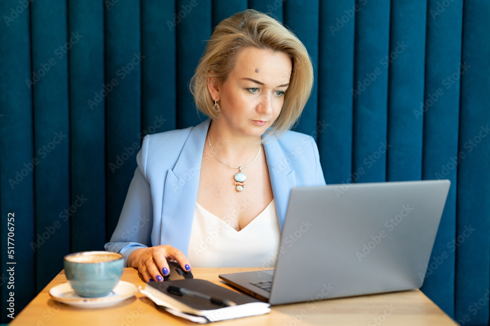 business woman. face beautiful caucasian young or mature professional career woman boss in business suit working on laptop. modern women entrepreneur working in restaurant and cafe small business business woman. face beautiful caucasian young or mature professional career woman boss in business suit working on laptop. modern women entrepreneur working in restaurant and cafe small business