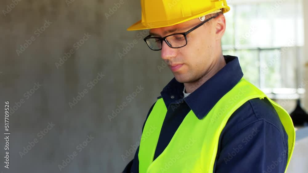 architecture, construction business and building concept - male builder in helmet and safety west with tablet pc computer at office architecture, construction business and building concept - male builder in helmet and safety west with tablet pc computer at office