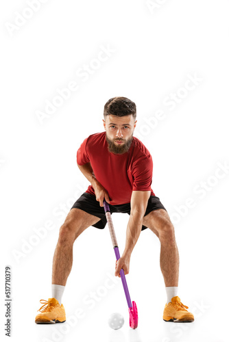 Portrait of young man, floorball player with floorball stick isolated on white background. Sport, competition and motion, movement, active lifestyle © master1305