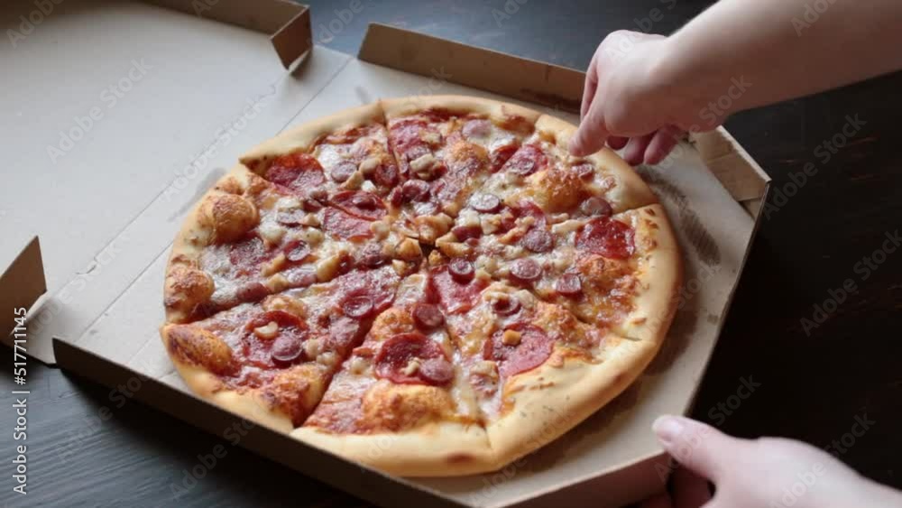 Delivery of pizza in a box. Girl opens a box with delicious juicy pizza Delivery of pizza in a box. Girl opens a box with delicious juicy pizza