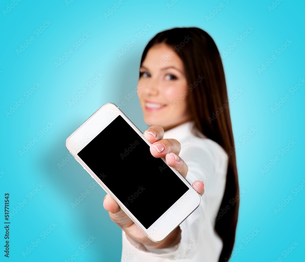 Happy young woman with smartphone on background. Blank screen mobile phone for graphic montage.