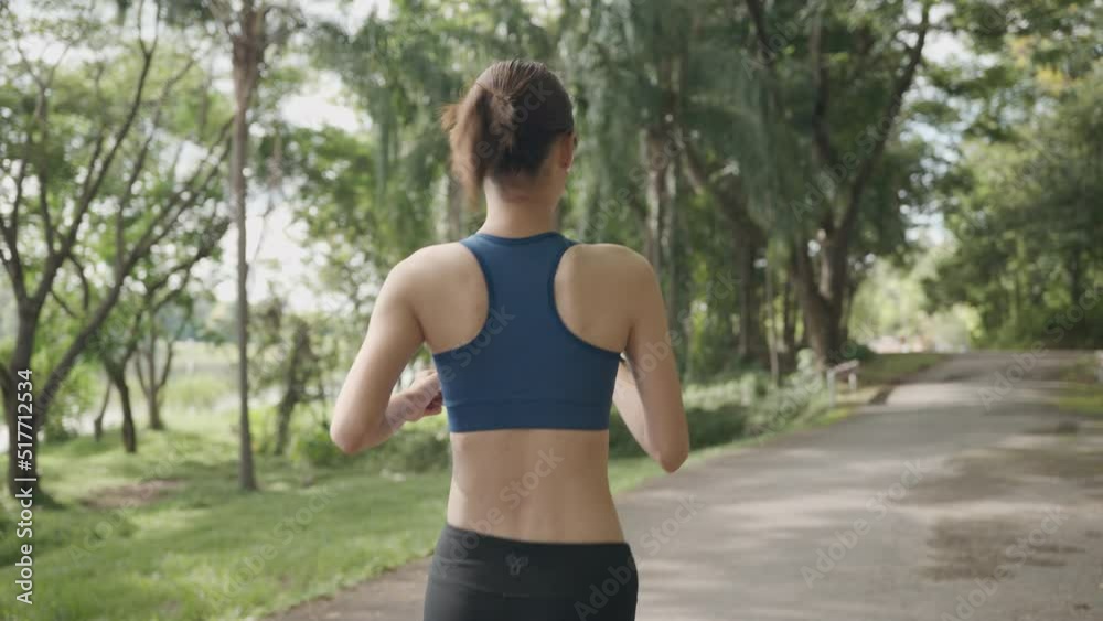 Young Asian women are exercising with outdoor running with a mountain and lake background in the morning. Concept healthy running and outdoor exercise,Tracking shot, 4k resolution. Young Asian women are exercising with outdoor running with a mountain and lake background in the morning. Concept healthy running and outdoor exercise,Tracking shot, 4k resolution.