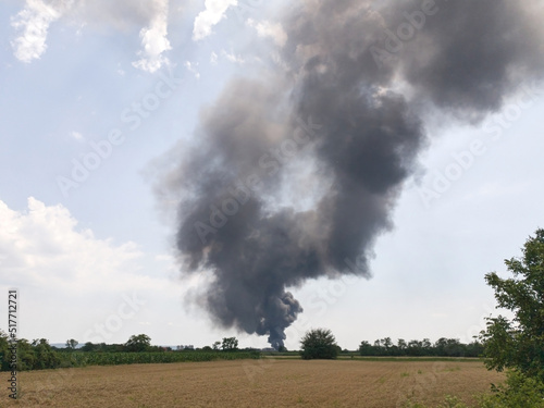 Big fire with smoke in rural countryside landscape.