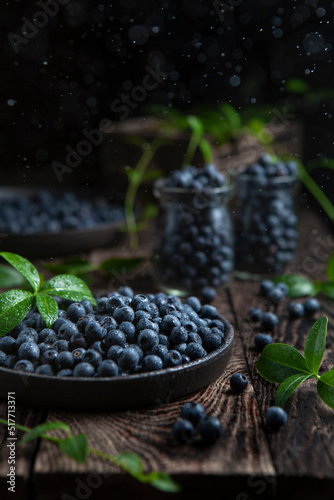 blackberry in a bowls and in two jars on the rustic wooden table