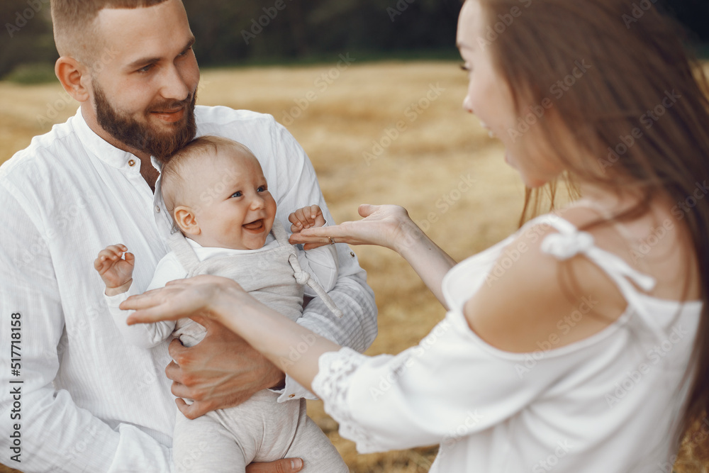 Fototapeta premium Family spend time in a summer field