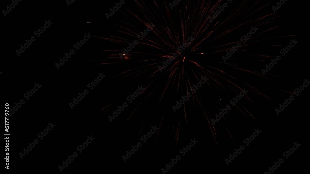 Red firework bursting in the night sky. Drone captures the firework exploding. Red firework bursting in the night sky. Drone captures the firework exploding.