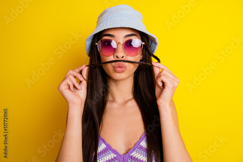 Portrait of cute charming female with fake mustache fooling around flirting with boyfriend isolated on yellow color background