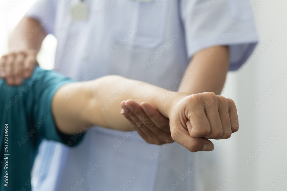 Concept of physical therapy and rehabilitation. A man with shoulder pain goes to the doctor, The doctor diagnoses the patient's arm pain and shoulder pain. Concept of physical therapy and rehabilitation. A man with shoulder pain goes to the doctor, The doctor diagnoses the patient's arm pain and shoulder pain.