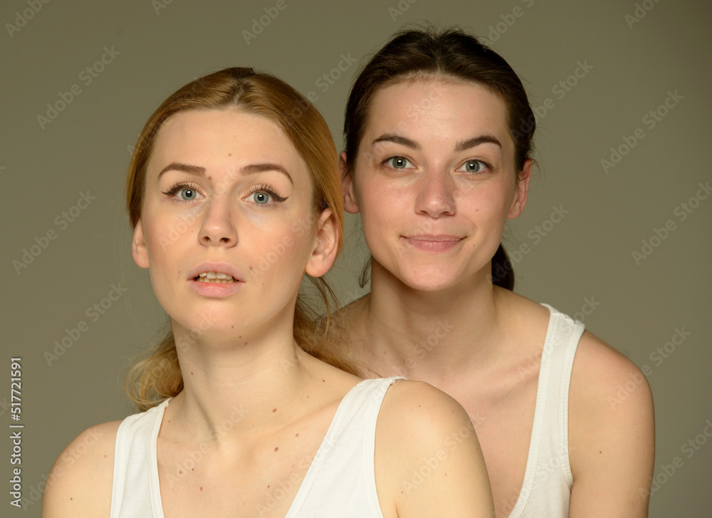 beauty portrait of two young attractive blonde and brunette girls on a light background isolated beauty portrait of two young attractive blonde and brunette girls on a light background isolated