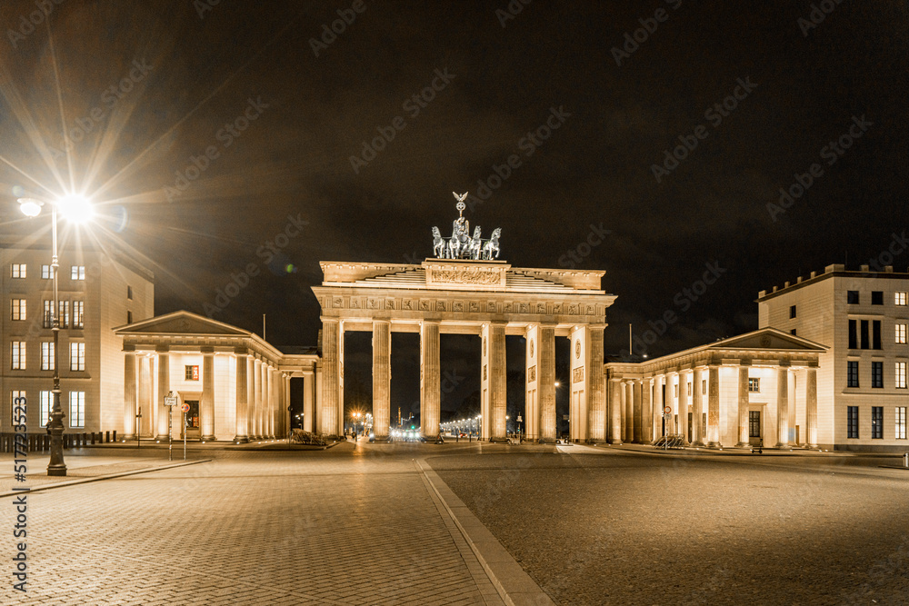 Brandenburg Gate in Berlin, Germany, light up at night casting long shadows from the east side - Wide Oblique Angle Brandenburg Gate in Berlin, Germany, light up at night casting long shadows from the east side - Wide Oblique Angle
