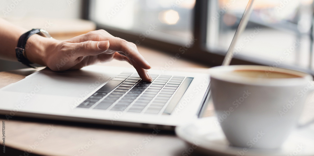 Woman working on laptop computer panoramic banner, female hands typing keyboard closeup, businesswoman or student girl using laptop at cafe Woman working on laptop computer panoramic banner, female hands typing keyboard closeup, businesswoman or student girl using laptop at cafe