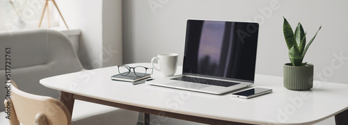 Workplace, laptop computer with coffee cup, mobile phone and glasses panoramic banner. Home office, business, technology, working from home, online studying, e-learning concept