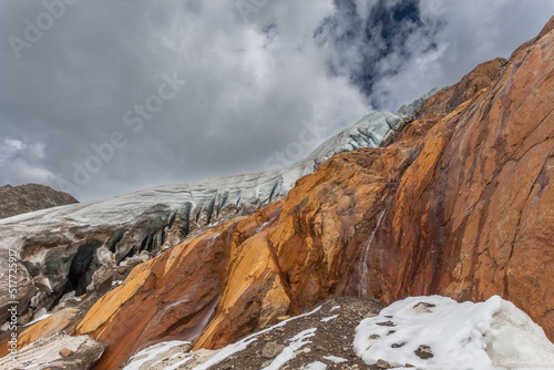 Particular morphologies of the seracs of the Vallelunga glacier above red rocks. The glacier is in rapid retreat caused by global warming, Alto Adige, Italy. Popular mountain with climbers photo