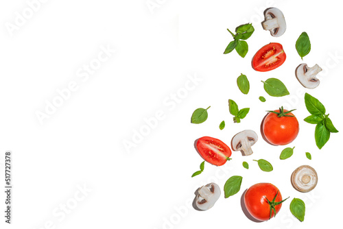 Mushrooms, tomato and basil isolated on white. Flatlay pattern on white background top view