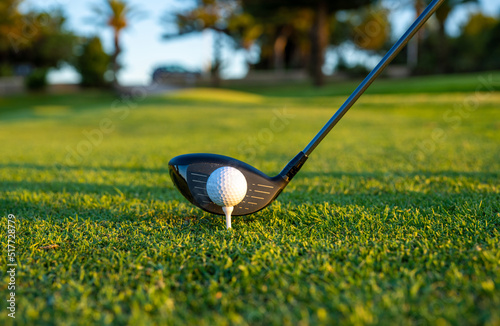 Close up of Golf ball on green grass ready to be struck.