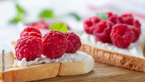 Toast with ripe raspberries close-up photo