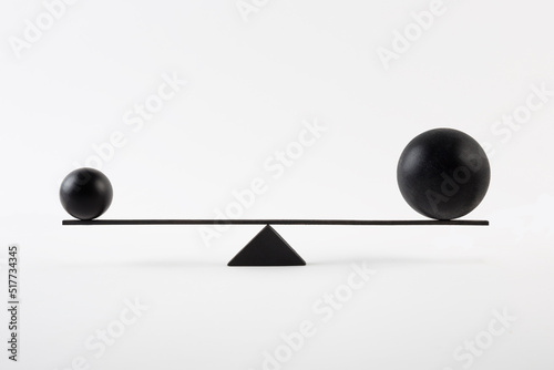 Black balls balancing on scales photo