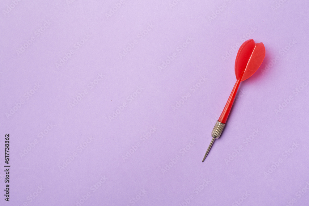 Red darts on color background, top view Red darts on color background, top view